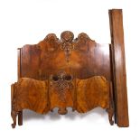 AN EARLY TO MID 20TH CENTURY BURR WALNUT VENEERED KING SIZE DOUBLE BED with scrolling cabriole feet,