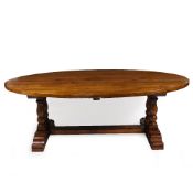 A LATE 20TH CENTURY LARGE HEAVY OAK OVAL DINING TABLE with turned supports united by a stretcher,