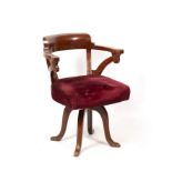 AN EARLY 20TH CENTURY MAHOGANY CAPTAIN'S CHAIR with arching back and red Draylon upholstered seat