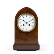 AN EDWARDIAN MAHOGANY MANTLE CLOCK the enamel dial with roman numerals, the movement striking the
