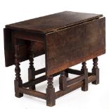 AN ANTIQUE OAK DROP LEAF TABLE with turned legs united by stretchers, possibly 17th century, 87cm