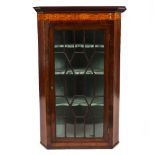 A GEORGE III MAHOGANY AND SATINWOOD CROSSBANDED CORNER CABINET with an astragal glazed door, 78cm