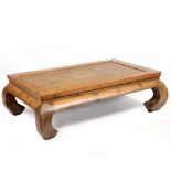 AN ORIENTAL STYLE PINE RECTANGULAR COFFEE TABLE with a rattan inset top, 152cm wide x 104cm deep x