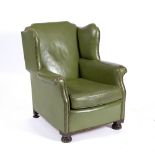 A GREEN LEATHER UPHOLSTERED WING BACK TUB CHAIR 74cm wide x 70cm deep x 83.5cm high Condition: