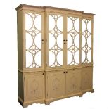 A MODERN CREAM PAINTED BREAKFRONT CABINET with four mirrored doors above four panelled doors and