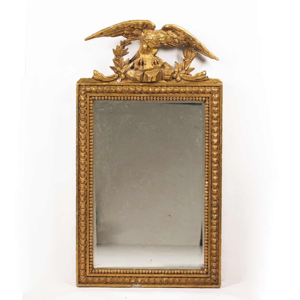 A 19TH CENTURY GILDED GESSO FRAMED RECTANGULAR WALL MIRROR with an eagle crest, 50.5cm wide x 94cm