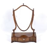 A GEORGE III MAHOGANY SERPENTINE FRONTED SHIELD SHAPED DRESSING TABLE MIRROR with three frieze