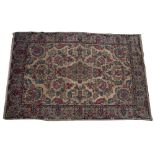 A PERSIAN STYLE CREAM GROUND CARPET with floral decoration, 210cm x 320cm Condition: in relatively