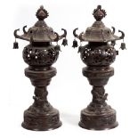 A PAIR OF ORIENTAL BRONZE TABLE LAMPS in the form of pagodas, each decorated with dragons, turtles