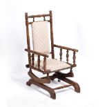 A LATE 19TH / EARLY 20TH CENTURY AMERICAN CHILD'S ROCKING CHAIR with turned supports, 41cm wide x