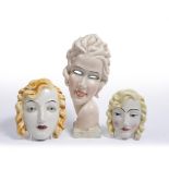 THREE ART DECO STYLE CONTINENTAL POTTERY MASK ORNAMENTS the largest 15cm wide x 32cm high Condition: