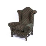 A LARGE UPHOLSTERED WING BACK ARMCHAIR 102cm wide x 79cm deep x 124cm high Condition: some wear to