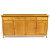 A MODERN LIGHT OAK SIDE CABINET of four drawers and four cupboards, 180cm wide x 45cm deep x 90cm