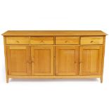 A MODERN LIGHT OAK SIDE CABINET of four drawers and four cupboards, 180cm wide x 45cm deep x 90cm