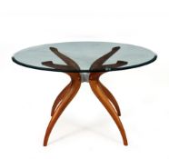 A CONTEMPORARY GLASS TOPPED CENTRE TABLE with four scrolling hardwood legs, 130cm diameter x 74cm
