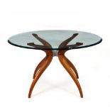 A CONTEMPORARY GLASS TOPPED CENTRE TABLE with four scrolling hardwood legs, 130cm diameter x 74cm
