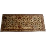 AN ORIENTAL HAND MADE WOOLLEN CARPET with stylised foliate decoration and a banded border, 179cm x