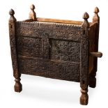 AN ANTIQUE AFGHAN CARVED WOODEN DOWRY CHEST of panel construction, the front with chip carved