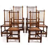 A SET OF SIX ARTS AND CRAFTS STYLE OAK DINING CHAIRS with spindle backs and turned supports to