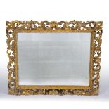 A LARGE GILDED WOODEN GESSO WALL MIRROR with acanthus scrolls, 128cm wide x 103cm high Condition: