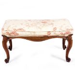 A 19TH CENTURY ROSEWOOD FRAMED UPHOLSTERED STOOL with cabriole legs and scrolling feet, 86cm wide