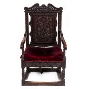 AN ANTIQUE CARVED OAK WAINSCOT CHAIR 60.5cm wide x 64cm deep x 112cm high Condition: later seat