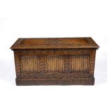 AN EARLY TO MID 20TH CENTURY OAK COFFER with chip carved panel sides, 107cm wide x 45cm deep x