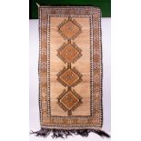 A MIDDLE EASTERN STYLE BROWN HANDMADE WOOLLEN RUG with banded border and four central diamond