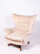 A MID TO LATE 20TH CENTURY UPHOLSTERED ROTATING ARMCHAIR