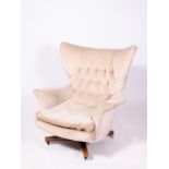 A MID TO LATE 20TH CENTURY UPHOLSTERED ROTATING ARMCHAIR