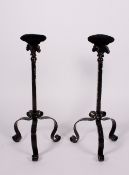 A PAIR OF 20TH CENTURY BLACK PAINTED WROUGHT IRON HAT STANDS with tripod bases, 57.5cm high