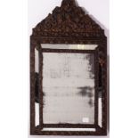 A LATE 19TH CENTURY CONTINENTAL PRESSED METAL FRAMED WALL MIRROR with sectional bevelled glass