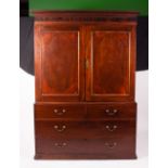 A 19TH CENTURY MAHOGANY LINEN PRESS with dog tooth moulded cornice, inlaid panelled doors