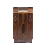 AN EARLY TO MID 20TH CENTURY GEC VALVE RADIO in a floor standing walnut case, 42cm wide x 27cm