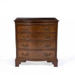 A GEORGIAN STYLE MAHOGANY SERPENTINE CHEST with a brushing slide over four long drawers, and