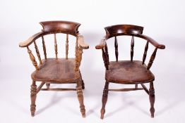 AN ASH AND ELM CAPTAINS TYPE WINDSOR CHAIR with carved saddle seat, turned spindle supports to the