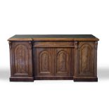 A VICTORIAN MAHOGANY INVERSE BREAKFRONT SIDEBOARD with central drawer and four doors with arching