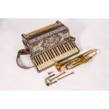 AN OLD TRUMPET in a tatty case together with a Paolo Soprani piano accordion, 48cm wide (2)