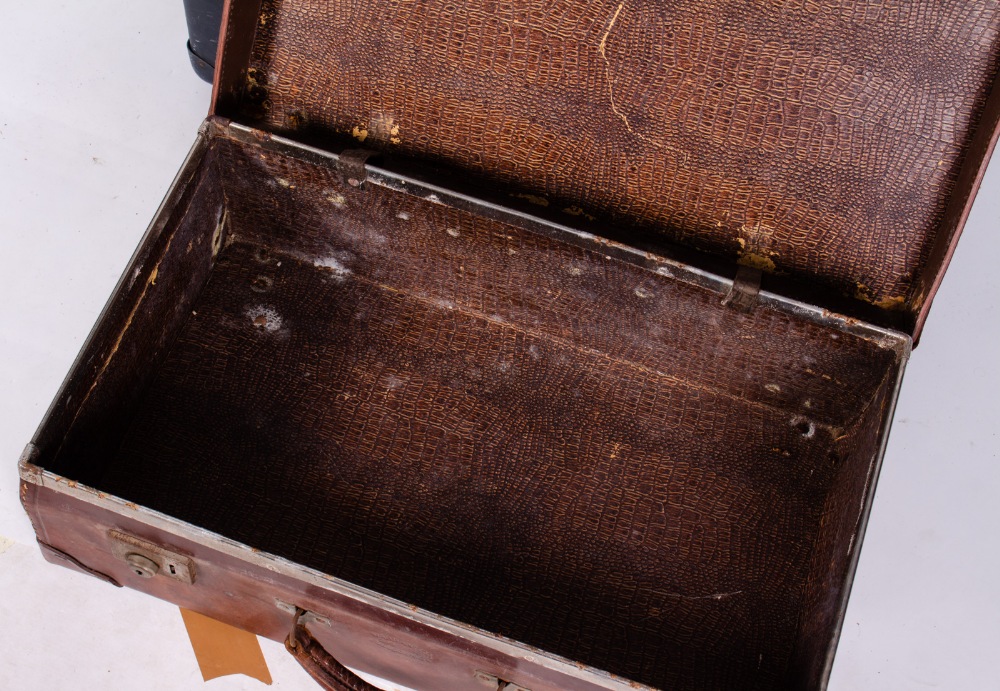 AN OLD LEATHER SUITCASE stamped 'Warranted Bullock Hide', 61cm wide together with a velum covered - Image 3 of 4