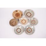 A GROUP OF SEVEN SOUTH EAST ASIAN POTTERY PIECES to include four dishes approximately 25cm diameter,