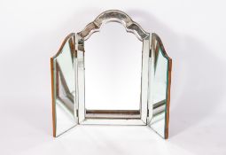 AN EARLY TO MID 20TH CENTURY THREE FOLD BEVELLED GLASS MIRROR with a shaped top and a walnut