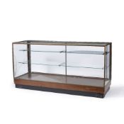 A BRASS FRAMED GLAZED SHOP'S DISPLAY COUNTER with adjustable glass shelves within, 183cm wide x 61cm
