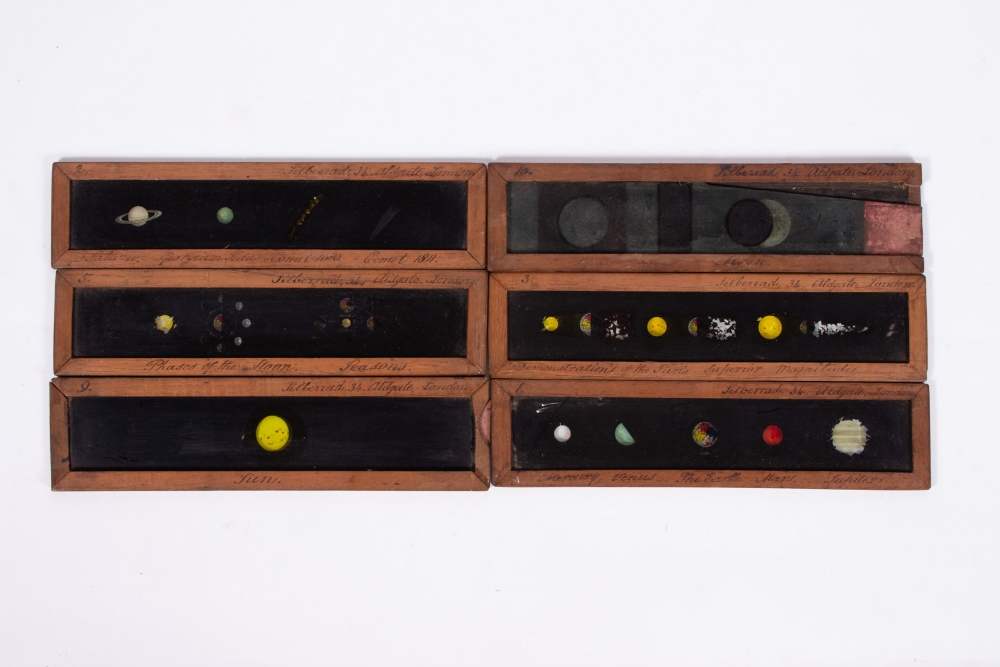 SIX 19TH CENTURY MAHOGANY FRAMED ASTRONOMY RELATED MAGIC LANTERN SLIDES each 29.5cm wide x 7.2cm