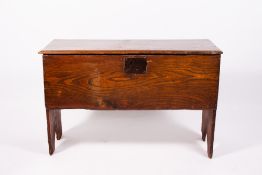 AN ANTIQUE ELM SIX PLANK COFFER with iron lock plate to the front and replaced hinges, 95.5cm wide x