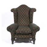 A LARGE UPHOLSTERED WING BACK ARMCHAIR 102cm wide x 79cm deep x 124cm high Condition: some wear to