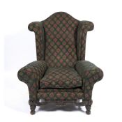 A LARGE UPHOLSTERED WING BACK ARMCHAIR 102cm wide x 79cm deep x 124cm high Condition: some wear to