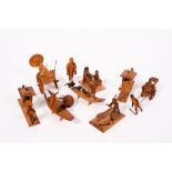 A GROUP OF EIGHT CHINESE SOFTWOOD CARVINGS to include figures transporting a dignitary in sedan
