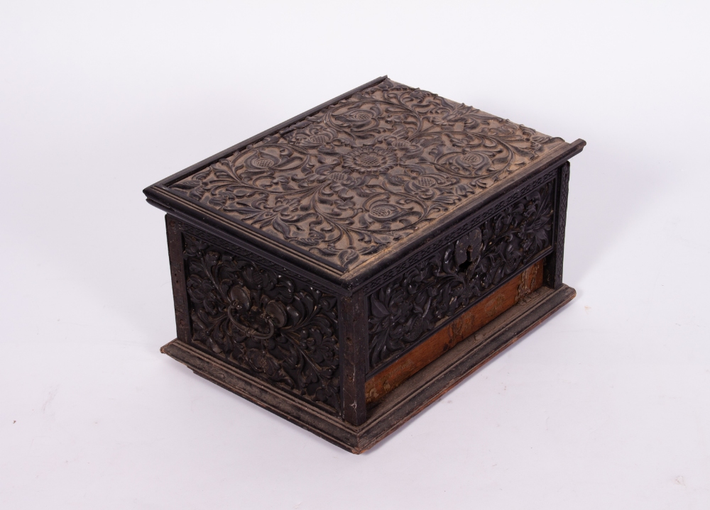 AN 18TH OR 19TH CENTURY ANGLO-INDIAN EBONY BOX with carved floral decoration and white metal hinges,