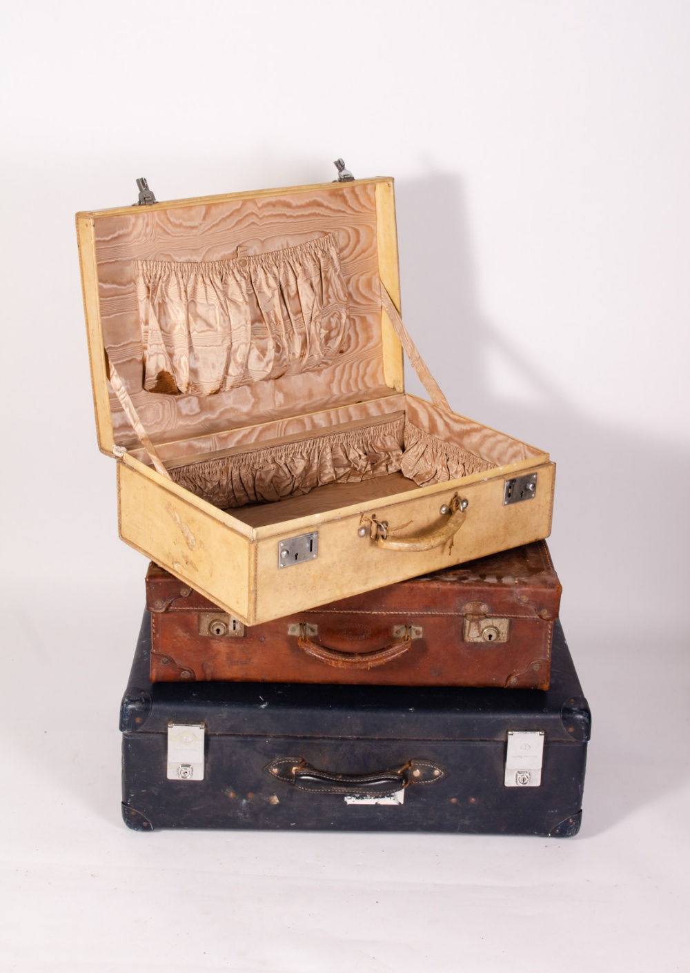 AN OLD LEATHER SUITCASE stamped 'Warranted Bullock Hide', 61cm wide together with a velum covered - Image 2 of 4