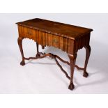 A HARDWOOD SIDE TABLE with a shaped top, two drawers, cabriole legs and claw and ball feet united by